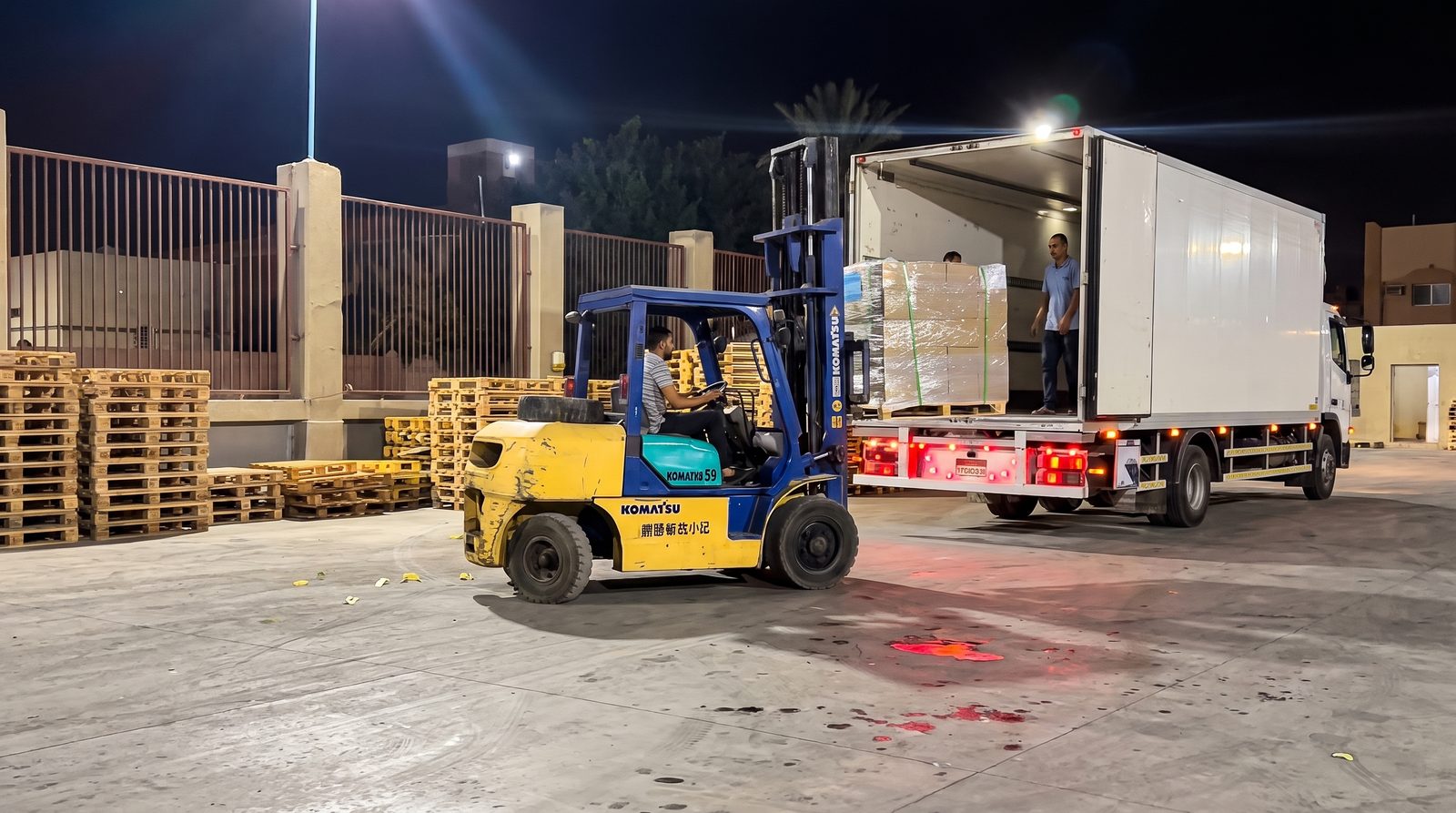 Forklift loading cargo truck